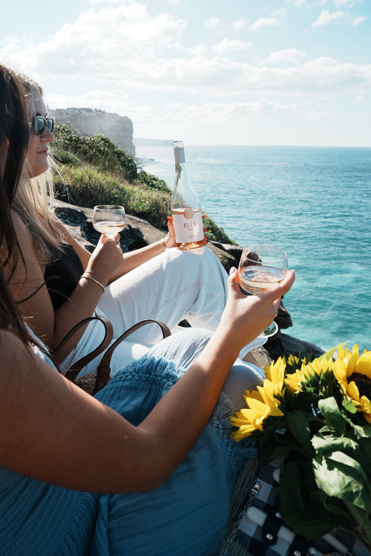 Friends enjoying Elle Rosé with pizza and pasta